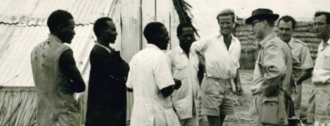 Settlers’ Irrigation Scheme at Hola Camp, Commandant Thompson, extreme right, looks on as visiting journalists and prisoners stand attentive in 1959.