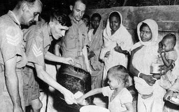 Men of the Royal Air Force feeding local children in Bengal during the famine,